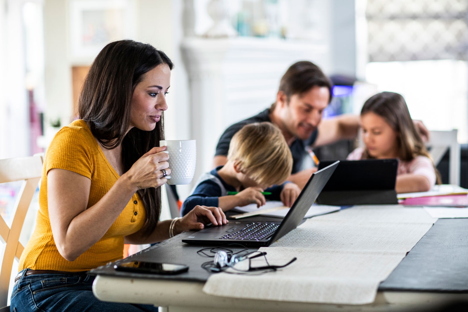 A husband and wife work from home with their children
