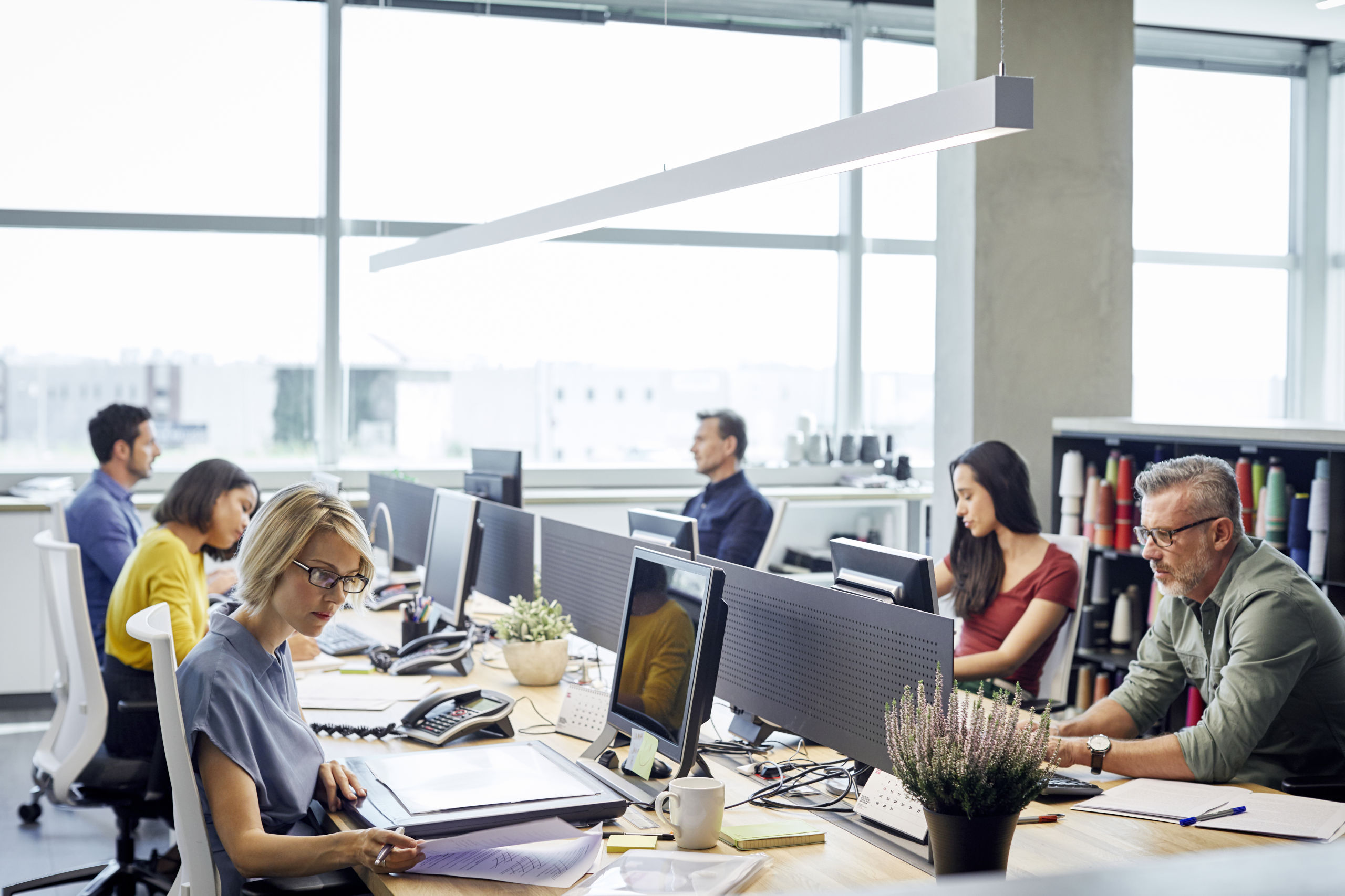 employees work on computers in office