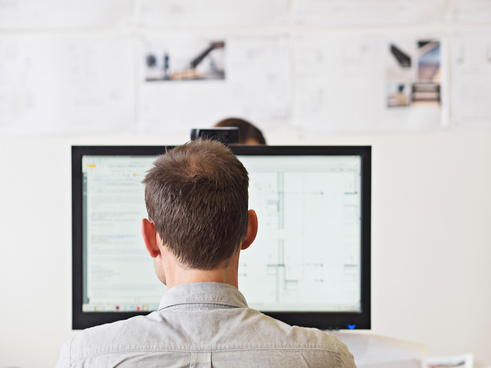 Man sits at computer and works