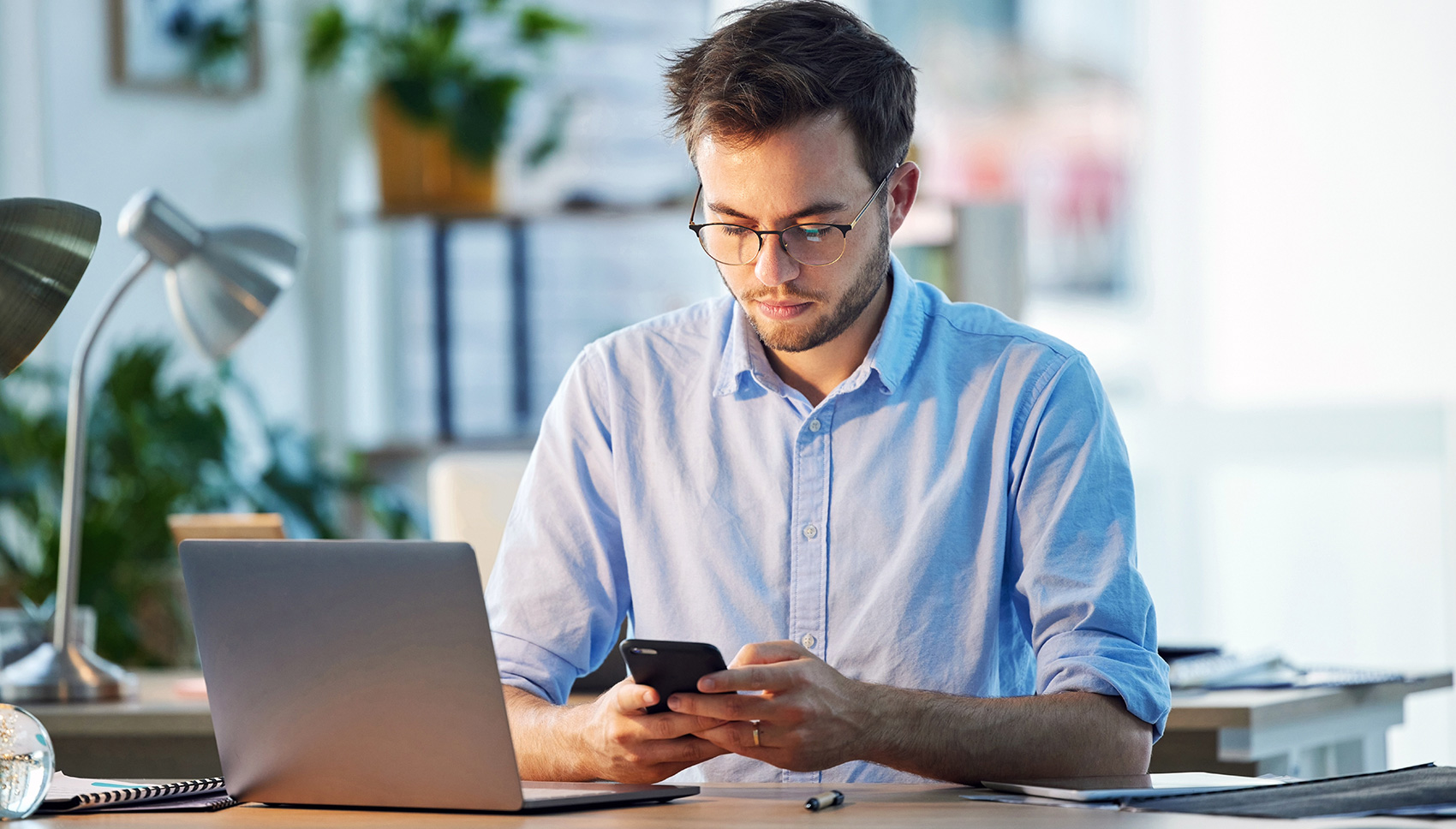 A man is sitting at his workplace in an office