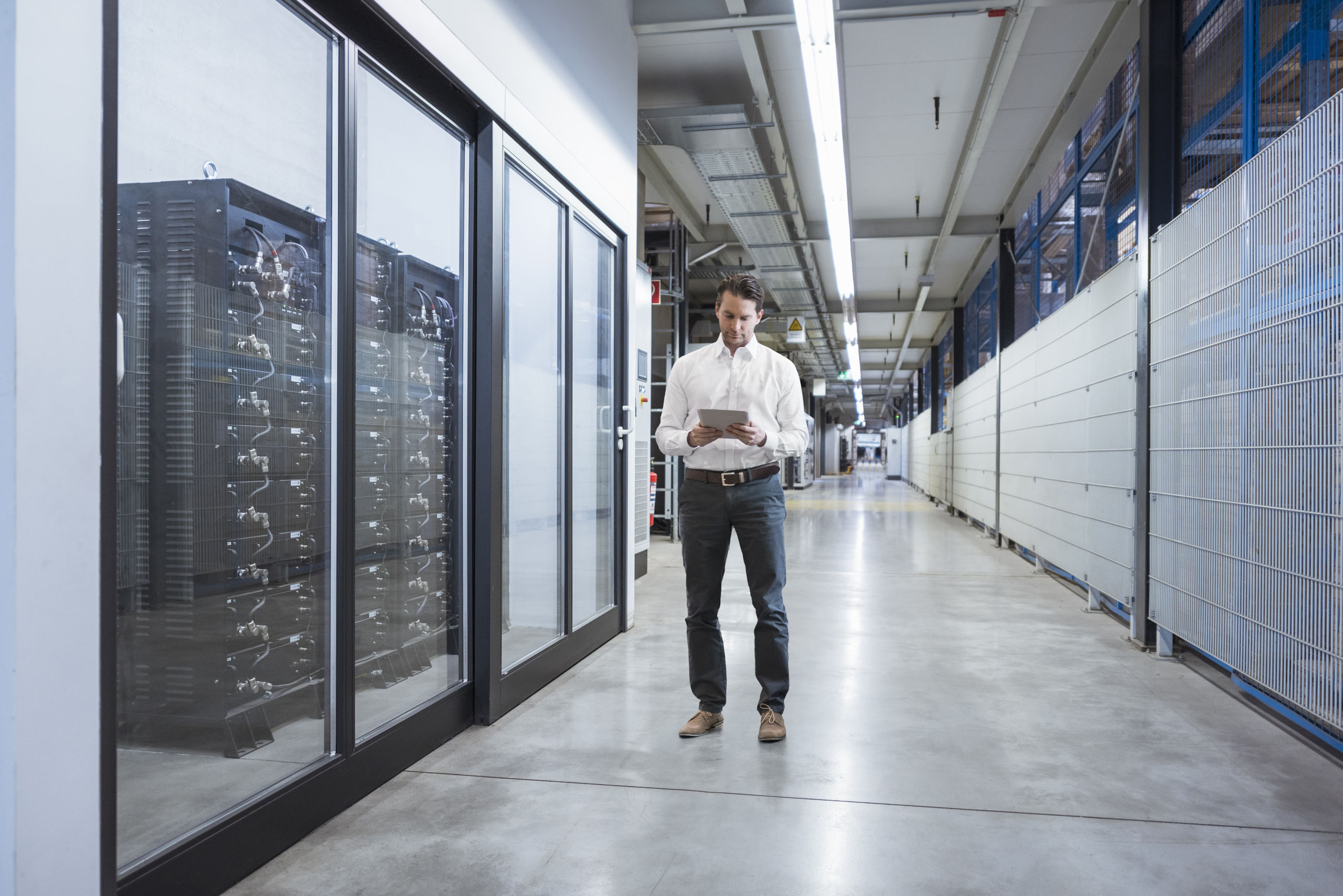 man with tablet in serverroom
