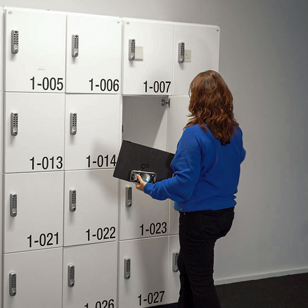 Photo of Jana Mahr, SAP Consultant, standing in front of lockers.