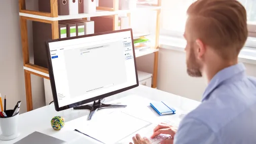 Man at computer working with AI tool for administration Assistent.IQ of the Bundesdruckerei