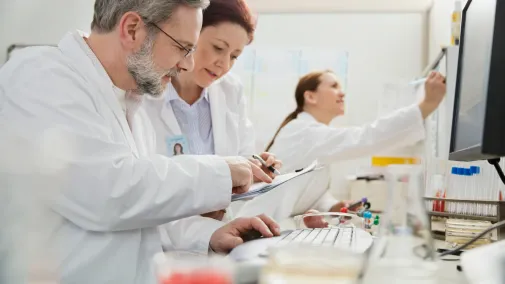 Doctor sitting at a computer in a practice laboratory