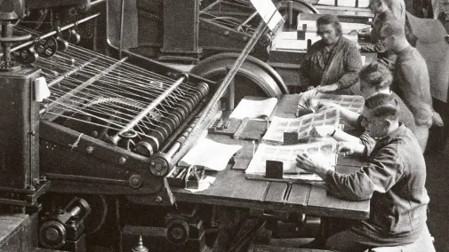 Historical photograph of employees at a machine