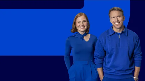 View of two employees against a blue background.