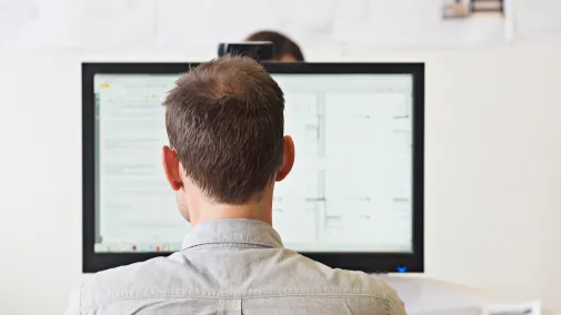 Man sits at computer and works