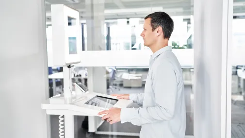 A man is standing in front of a piece of equipment from Maurer.