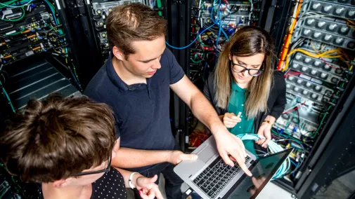 Three people are programming