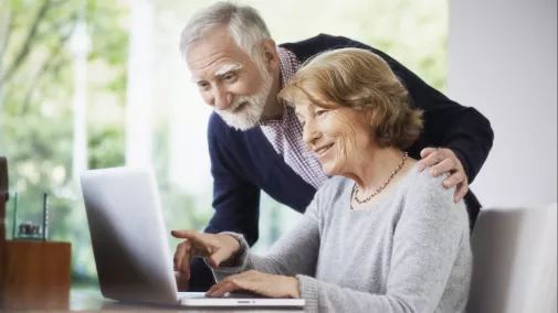 pensioner women man notebook table at home pensioner women man notebook table at home