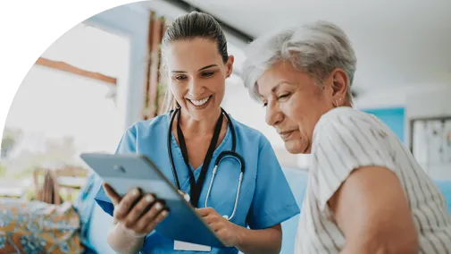 Two woman look at a tablet