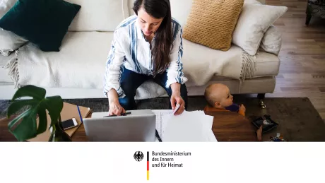 Woman with a baby sitting in front of a laptop, BMI