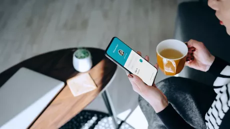 women sitting on a table with smartphone