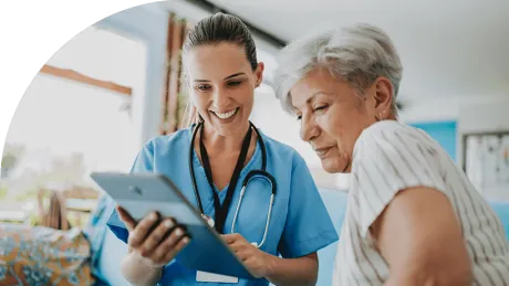 Two woman look at a tablet