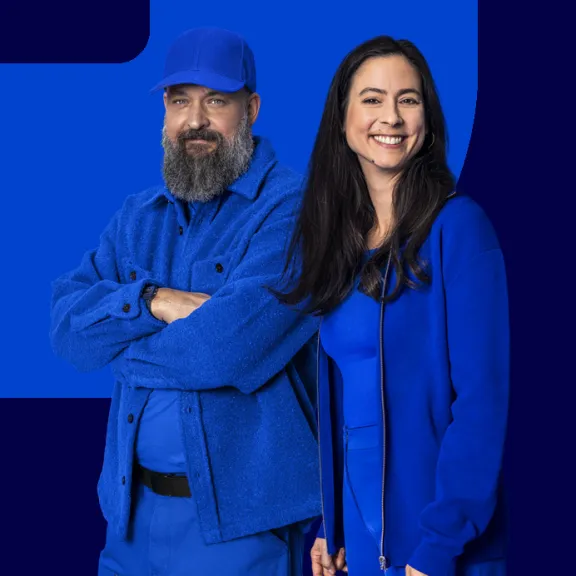 View of two employees against a blue background.